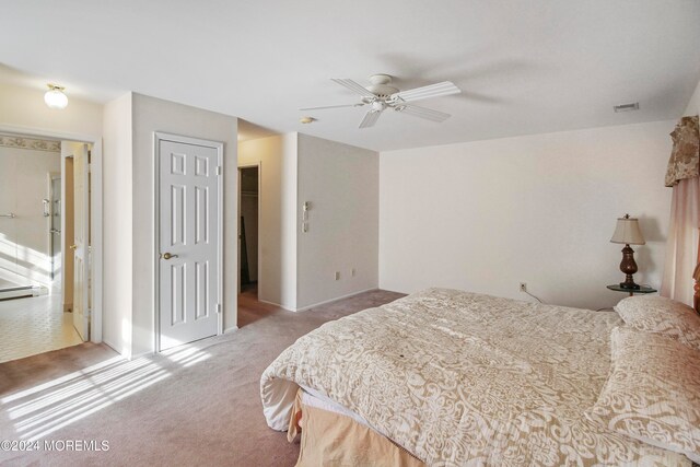 carpeted bedroom featuring a closet and ceiling fan