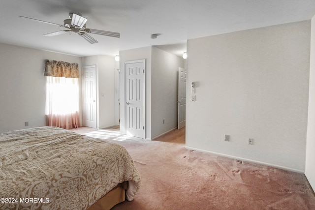 bedroom featuring ceiling fan and light carpet