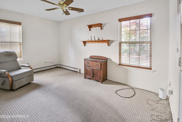 sitting room with light carpet, a baseboard radiator, and ceiling fan