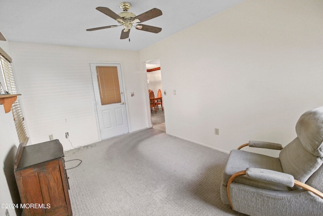 sitting room featuring light colored carpet and ceiling fan