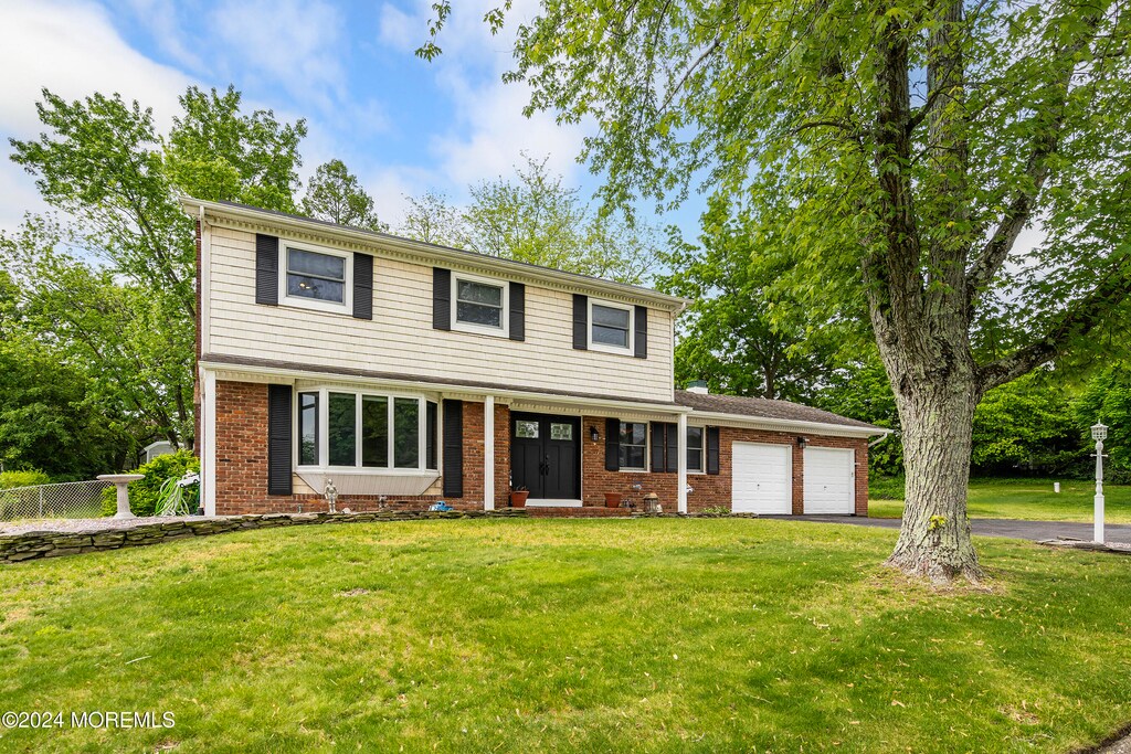 59 Westbrook Rd, Howell, NJ 07731 - view of front of property with a front lawn and a garage