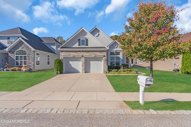 craftsman house with a garage and a front lawn