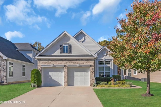 view of front of home featuring a front lawn and a garage