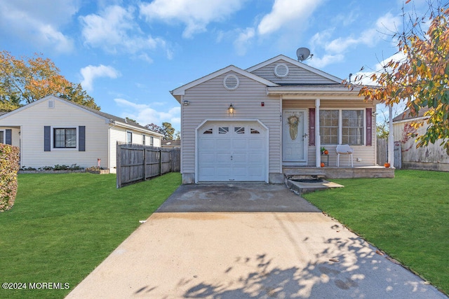 view of front of home with a garage and a front lawn