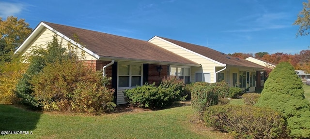 view of property exterior with a lawn