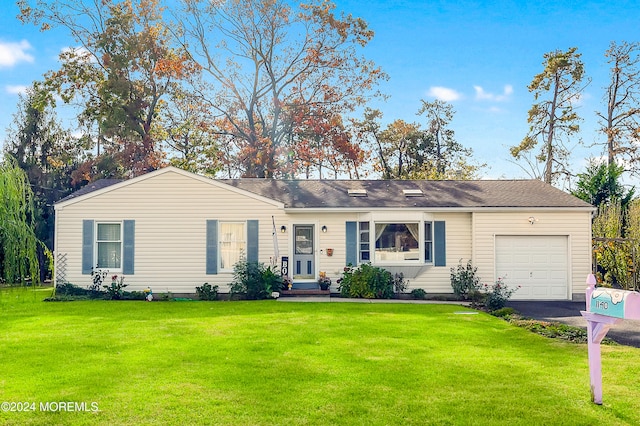 ranch-style home with a front yard and a garage