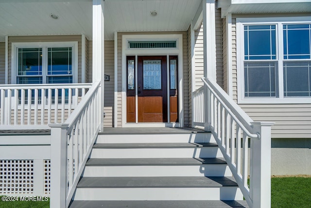 view of exterior entry with a porch