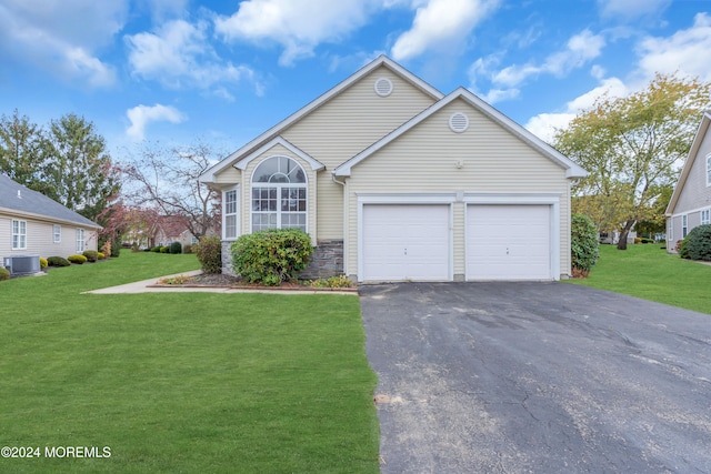 view of front facade featuring a front lawn, central AC, and a garage