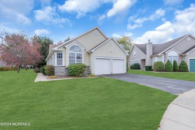 view of front of house with a front lawn and a garage