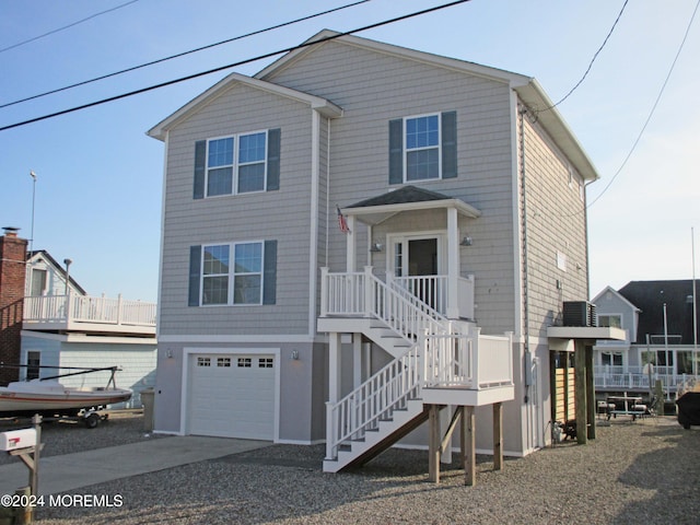 view of front of property featuring a garage and central AC unit