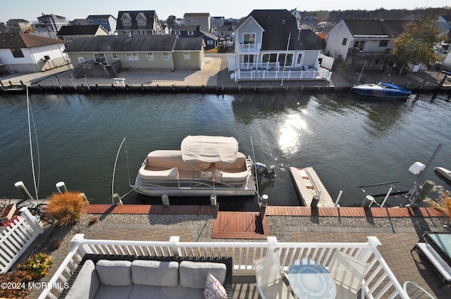 dock area with a patio area, outdoor lounge area, and a water view