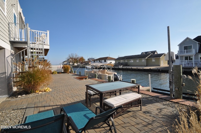 view of patio featuring a dock and a water view