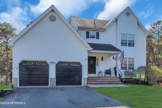 view of front facade with a front yard and a garage