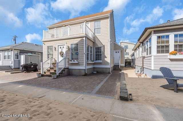 back of property with a patio and a balcony