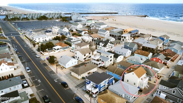 bird's eye view with a water view and a view of the beach