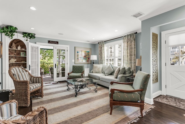 living room featuring a wealth of natural light, french doors, and hardwood / wood-style floors