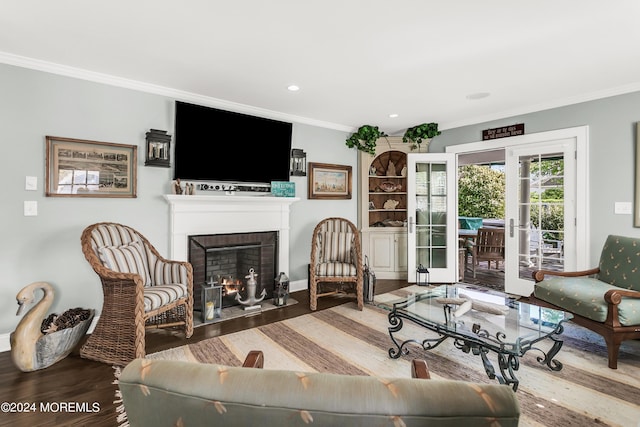 living room featuring crown molding, a fireplace, and hardwood / wood-style floors