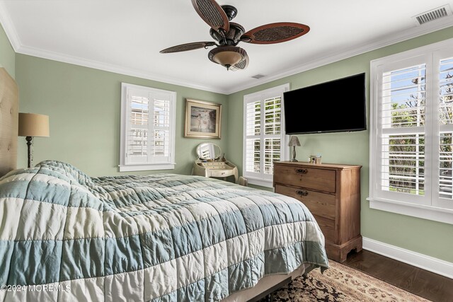 bedroom with crown molding, dark hardwood / wood-style floors, and ceiling fan