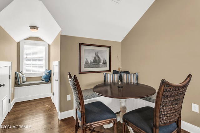 dining room with lofted ceiling and dark hardwood / wood-style floors