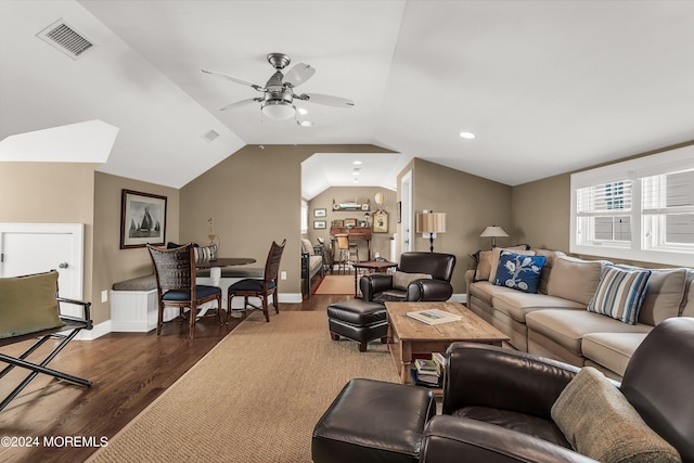 living room featuring dark wood-type flooring, ceiling fan, and vaulted ceiling