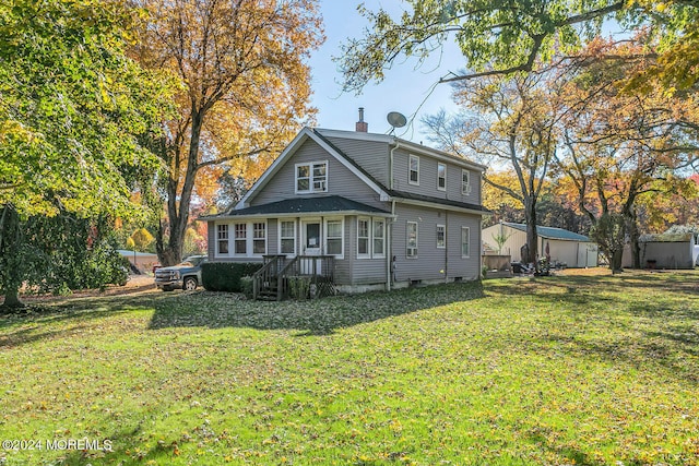 rear view of property featuring a wooden deck and a lawn