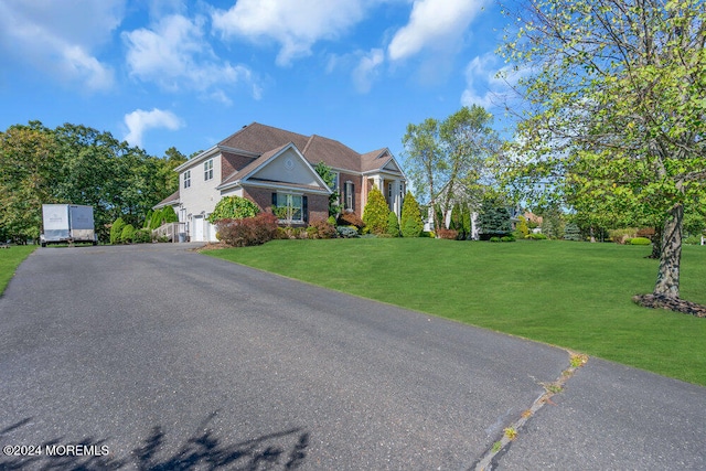 view of front of house featuring a front yard and a garage