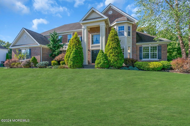 greek revival inspired property with a front lawn