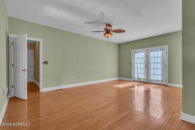 spare room featuring french doors, light wood-type flooring, and ceiling fan