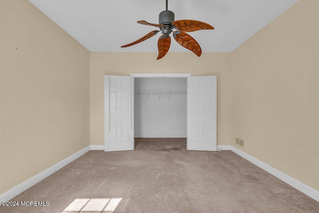 unfurnished bedroom with light carpet, a closet, and ceiling fan