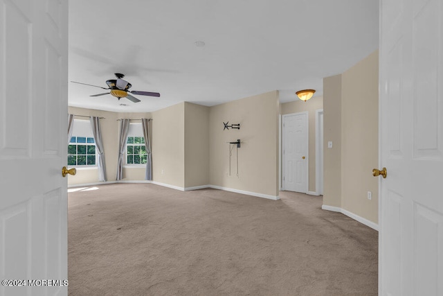 carpeted empty room featuring ceiling fan