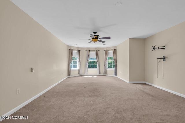 carpeted spare room with ceiling fan