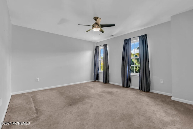 empty room with ceiling fan and light colored carpet