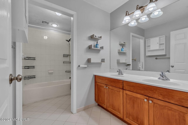 bathroom with vanity, tiled shower / bath combo, and tile patterned floors