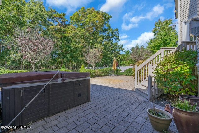 view of patio / terrace with a hot tub