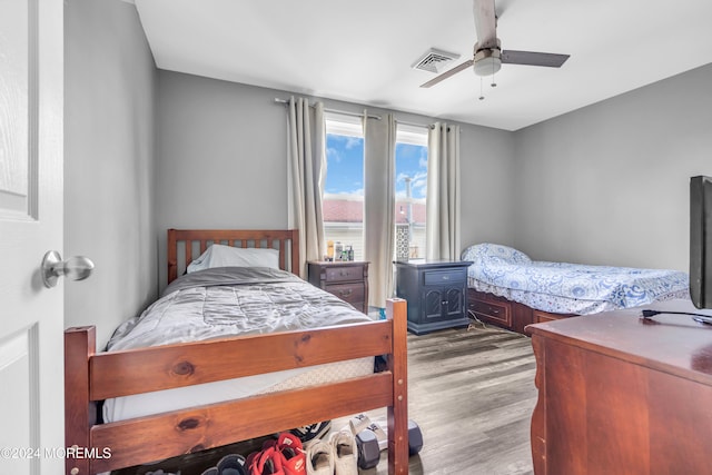 bedroom with ceiling fan and hardwood / wood-style flooring