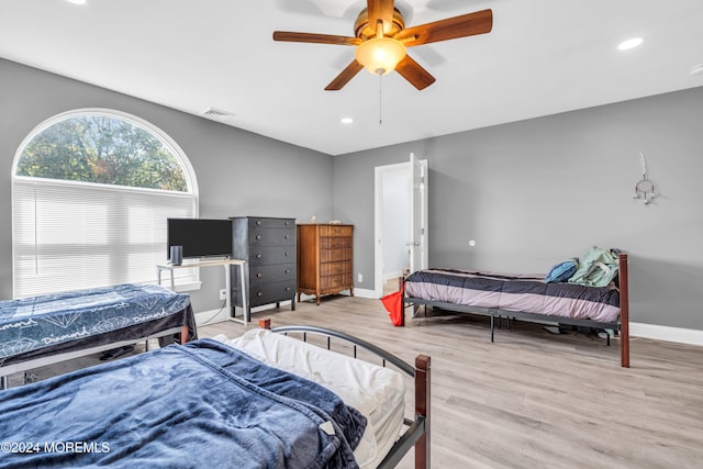 bedroom with hardwood / wood-style floors and ceiling fan