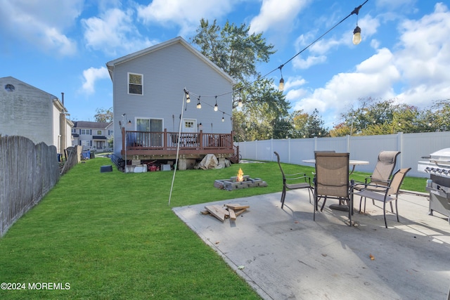 back of property with a patio, a deck, and a yard