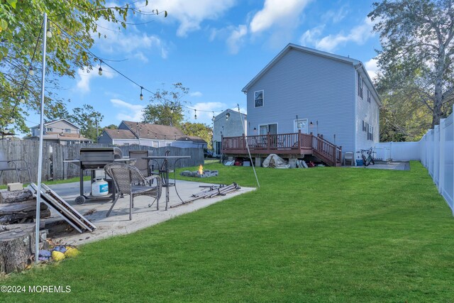 view of yard with a wooden deck and a patio area