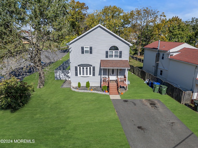 view of front of home featuring covered porch and a front lawn