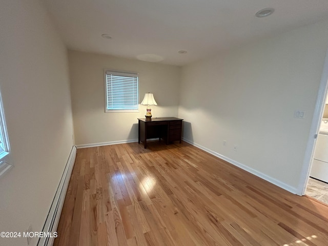 spare room with light hardwood / wood-style floors and baseboard heating