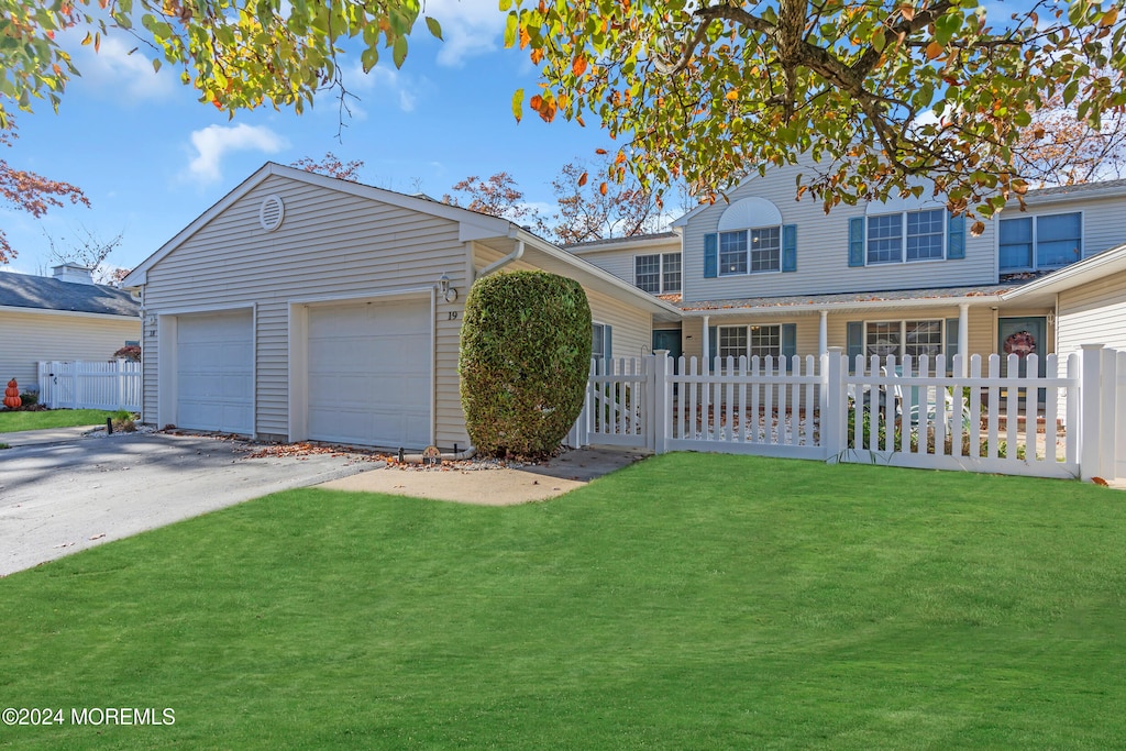 view of front property featuring a front yard and a garage