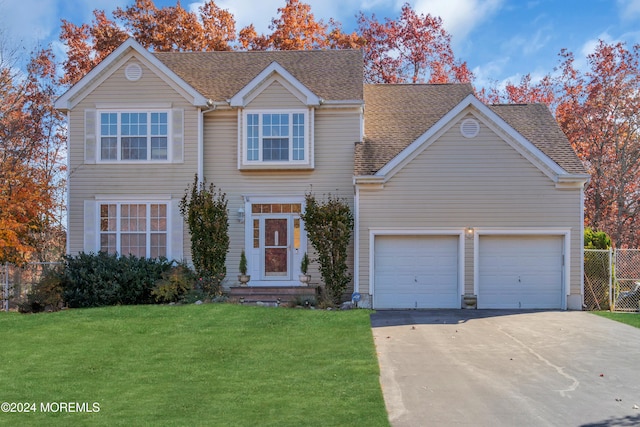 view of front of house with a front yard and a garage