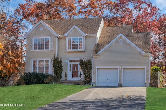 view of front of house with a front yard and a garage