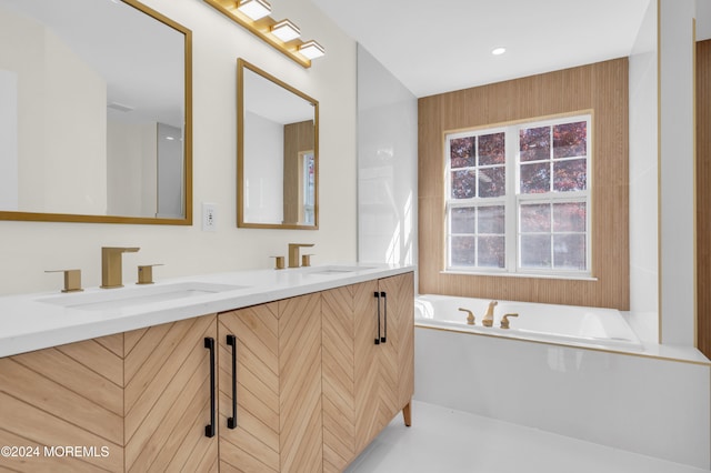 bathroom featuring vanity and a tub to relax in