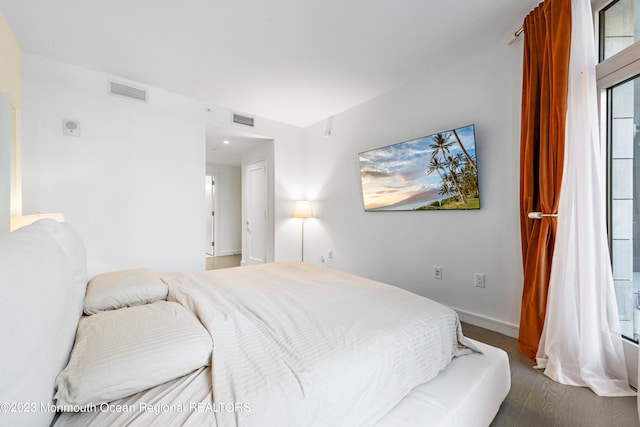 bedroom with dark hardwood / wood-style floors