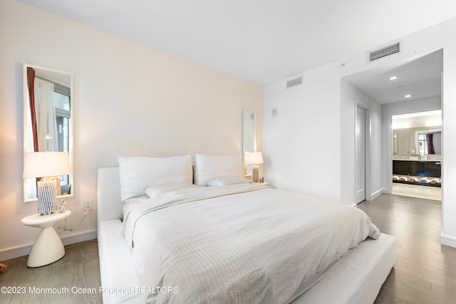 bedroom with dark wood-type flooring