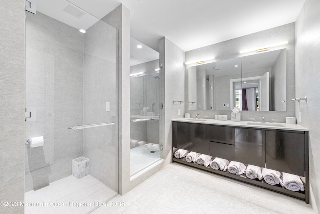 bathroom with vanity and a shower with shower door