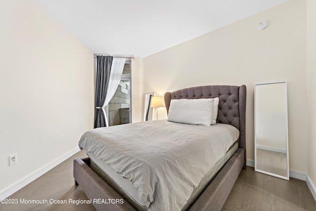 bedroom with hardwood / wood-style flooring