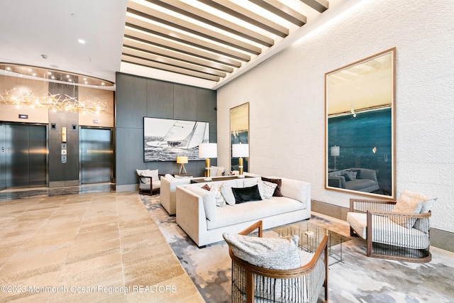 living room featuring beam ceiling and elevator