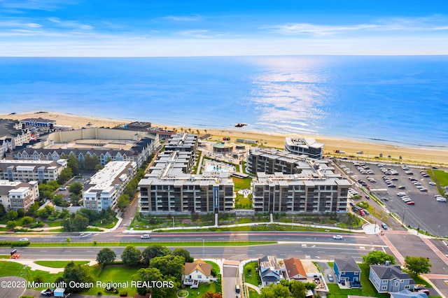 bird's eye view featuring a water view and a beach view